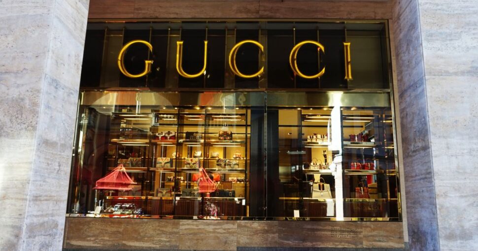 Schaufenster eines gehobenen Modegeschäfts mit luxuriöser Beleuchtung und Ausstellungsstücken.
